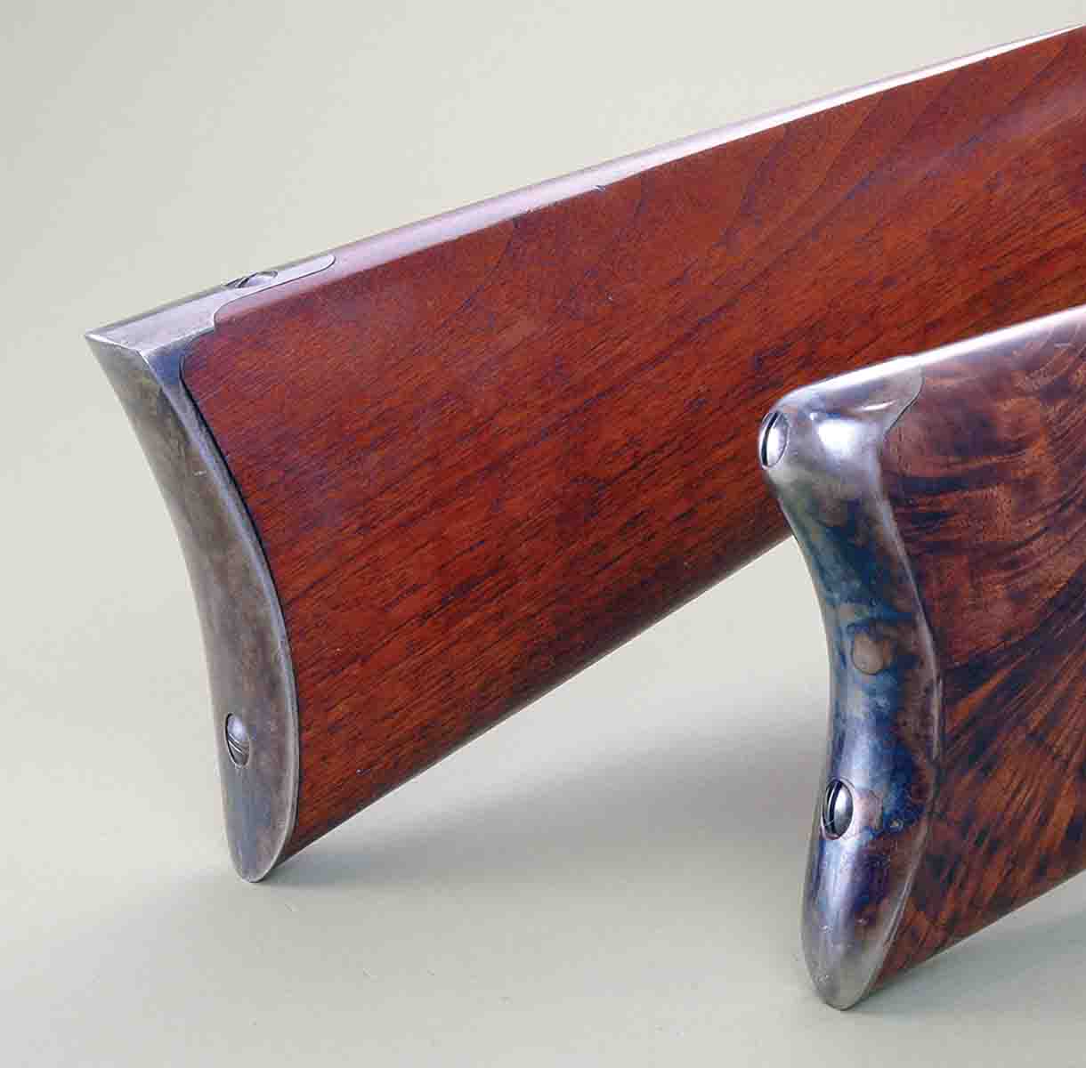 These buttplates are on modern reproductions of late nineteenth-century designs. Mike considers the Remington style (front) as the worst ever designed. The rear one is a reproduction of a Sharps Model 1874 buttplate.